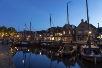 Evening mood, blue hour, old harbour at the Eemmeer, historic centre of Spakenburg,