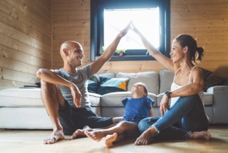 Young family with a girl, spending time at home on the weekends. Loving family resting on the