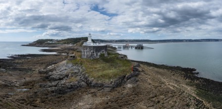 Aerial view of the Mumbles headland with the historic lighthouse and piers in Swansea Bay