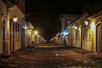 Atmospheric night view of illuminated street and buildings in historical center of Paraty, Brazil,
