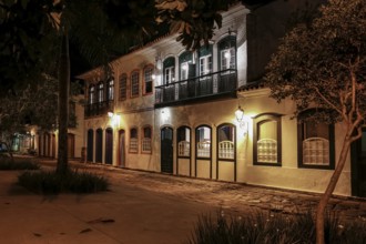 Atmospheric night view of illuminated street and buildings in historical center of Paraty, Brazil,
