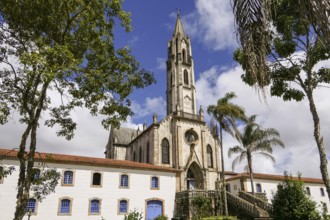 View to church and buildings with blue sky and white clouds, Sanctuary Caraça, Minas Gerais,