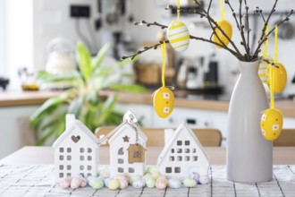 Key to house of cozy home with Easter decor with rabbit and eggs on table of kitchen. Building,