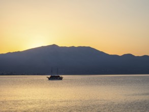 Ship in the morning light in front of sunrise, Peljesac peninsula, view from Korcula, Dalmatia,