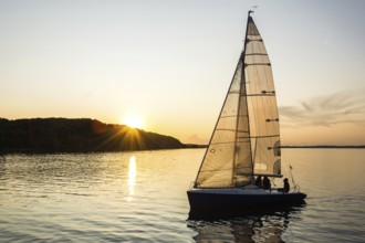 Sailing boat sailing into the harbor during beautiful sunset