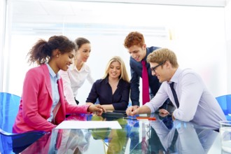 Multi ethnic teamwork of young business people meeting working at office