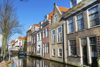Colorful street view with traditional dutch houses, canal in downtown of popular Holland