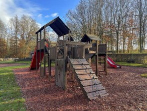 Colorful playground with climbing stairs and slides on yard in the park