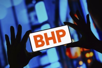 In this photo illustration, the BHP Billiton logo is displayed on a smartphone screen