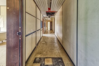A long, empty corridor with closed doors on both sides and a tiled floor, Institute of Molecular