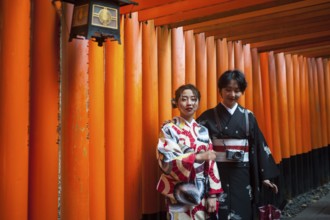 24.12.2017, Kyoto, Japan, Asia, Two young Japanese women stand in one of the torii pathways leading