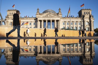 21.10.2023, Berlin, Germany, Europe, People walk past the Reichstag in Berlin's Mitte district on a
