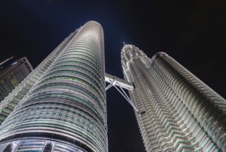 A picture of the Petronas Twin Towers as seen from below at night