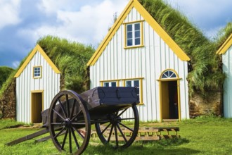 The ancient two-wheeled wooden cart on the front lawn. The village first settlers in Iceland. The