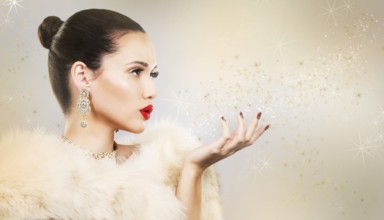Upscale woman wearing gold jewellery and red lipstick on light background, Toronto, Canada, North