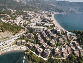 Private beach near modern villas with terraces on the seafront. Dukley, Budva, Montenegro. Drone.