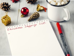 Christmas gifts shopping planning. Make shopping or to-do list for Christmas. Notebook, mug hot