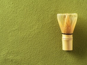 Powdered green tea Matcha background and bamboo whisk Chasen. Copy space for text or design