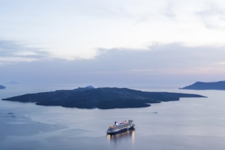 Evening atmosphere, view from Fira, cruise ship in the archipelago of Santorini, Cyclades, Greece,