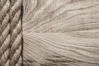 Vintage twisted jute cables on wooden board copy space