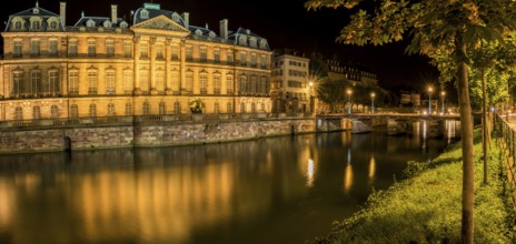 Night panoramic view with the Rohan Palace and the river Ill, with building and yellow lights