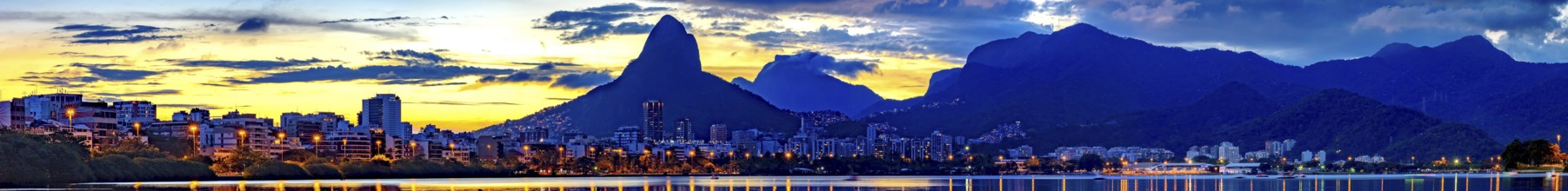 Panoramic image of summer sunset seen from the lagoon Rodrigo de Freitas with the buildings of the