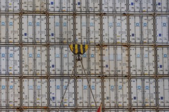 Stack of freight containers in the harbour, arranged in even rows, hook in the middle, Bremerhaven,