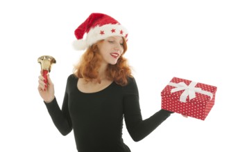 Young red haired woman with Christmas gift and bell of Santa Claus