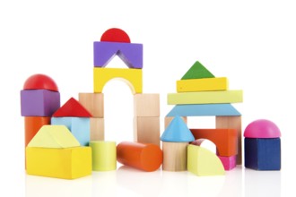 Village built from colorful toy blocks isolated over white background