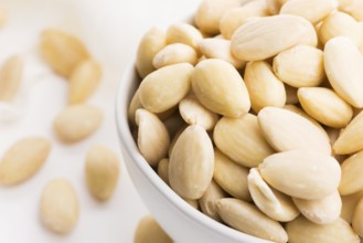 Bowl of almonds on a white background