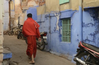 Priest walking in narrow lane, jodhpur, rajasthan, India, Asia, NOMR, Asia