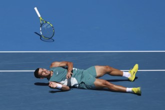 Spanish tennis player Carlos Alcaraz (ESP) diving for forehand shot and falling to the ground at