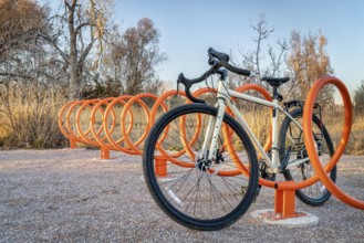 Touring bike parked in colorful helix bike racks along a trail in Fort Collins, Colorado - outdoor