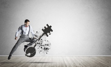Breaking through access concept with furious man in room crashing concrete key