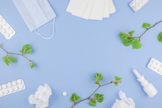 Creative flat lay concept of seasonal spring pollen allergy with napkins, pills, face mask, drops