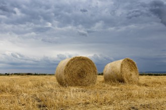 Straw bales on farmland Storm clouds