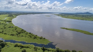 Aerial view Magdalena River and green rural landscape with blue sky and white clouds in Colombia