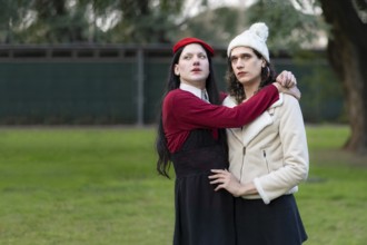 Couple of transgender women posing sensually in a park