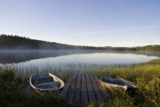 Moored boats in Lake Tevsjon near the Swedish village Ljusnedal early in the morning
