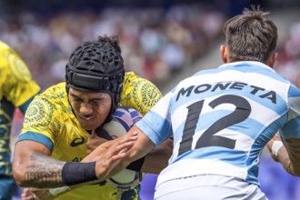 Men?s Pool B Rugby Seven: Team Australia back Dietrich Roache (4) (AUS) fights for the ball during
