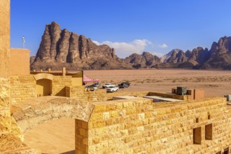 Jordan, Wadi Rum, November 2, 2022: Cars near the entrance to Wadi Rum desert with Seven Pillars of