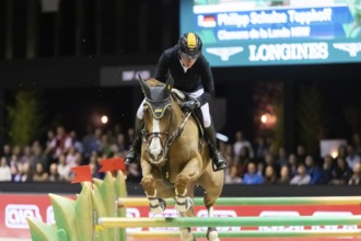 Philipp Schulze Topphoff of Germany competes in the equestrian Audi Grand Prix at Jumping