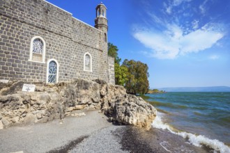Church on the shore of the Sea of Galilee - Tabgha. High waves on the Sea of Galilee. Christian