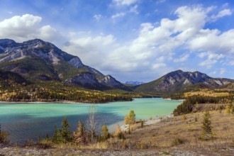 Lush multicolor autumn in the Canadian Rockies. The valley and azure icy water of the Kananaskis