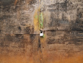 Metal rusty gate and padlock. Texture of rusty metal