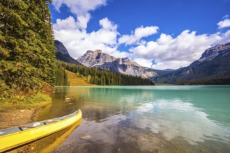 Sunny day in autumn Yoho National Park. In shallow water, the boat is moored. The concept of
