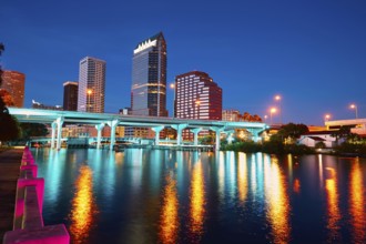 The Tampa skyline reflects on the Hillsborough River at sunset