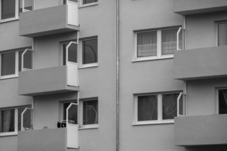 Modern residential building facade with balconies and windows, showcasing urban living and
