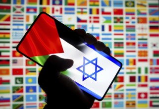 In this photo illustration, the flag of Israel and Palestine is displayed on a smartphone screen
