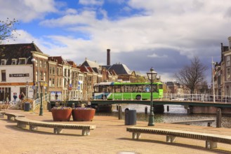Leiden, Netherlands, April 7, 2016: Street view with traditional houses, bridge and people in